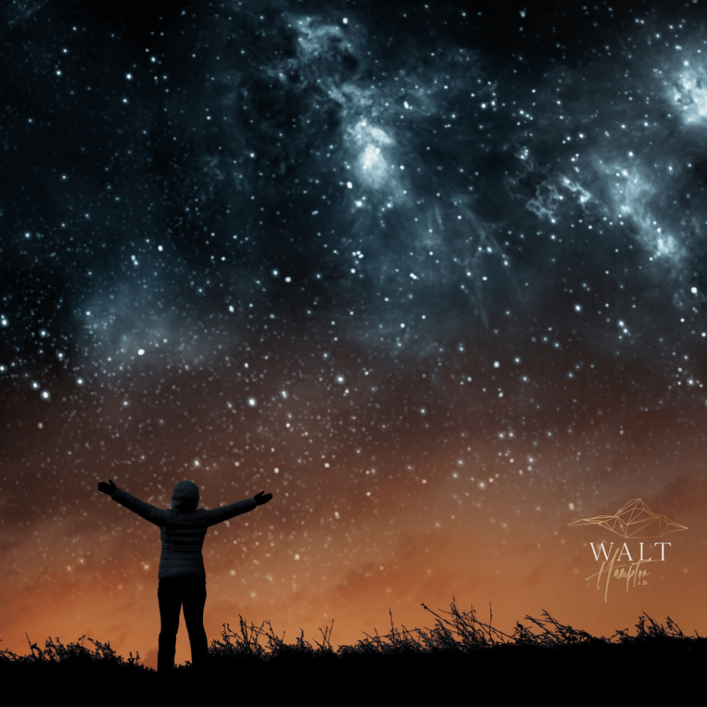 a silhouette picture of woman looking at the sky full of stars. lifting her arms up above.